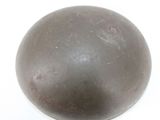 a metal ball on a white surface with a white background
