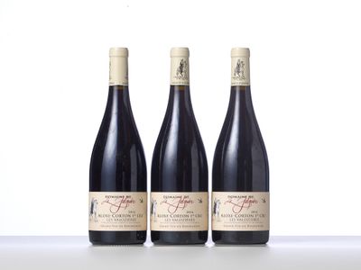 three bottles of wine sitting on top of a white table