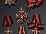 several medals and ribbons are displayed on a black surface