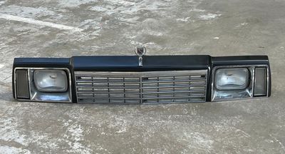 a black car front bumper with two lights on it