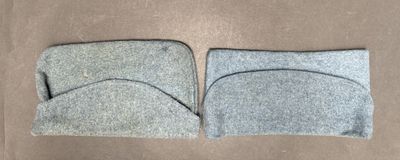 two pieces of felt sit on top of each other on a brown surface