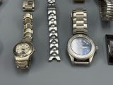 a lot of watches that are sitting on a table
