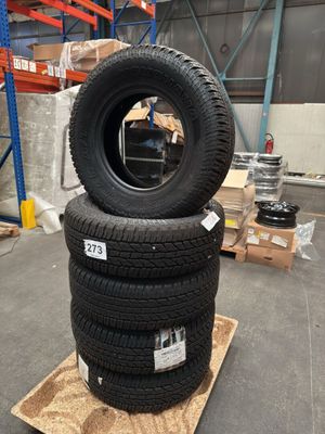 two tires stacked on top of each other in a warehouse