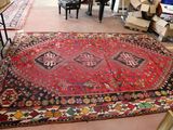a large red rug on the floor in a room