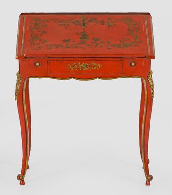 a red desk with gold trimming and a drawer on top
