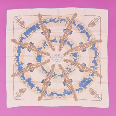 the square scarf has a blue and white design on it