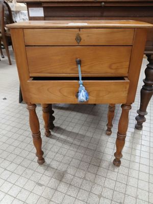 a small wooden table with a drawer on top of it