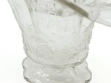 a clear glass vase with a spoon in it