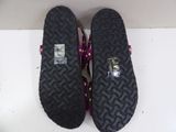 pair of black and pink slippers on a white surface