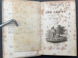 an old book with a pipe sticking out of it on a table