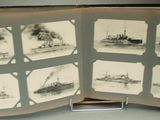 many pictures of ships in a book on a table