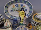 many plates and bowls on a table with a figurine
