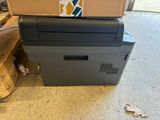 a printer sitting on top of a box on the floor