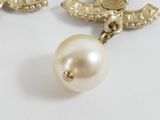 pearl and gold chandelier earrings on a white surface