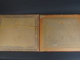 an old picture of two open wooden boxes on a table