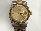 an image of a gold and silver rolex watch on a white background