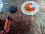 an overhead view of a living room with a rug, chair, and table