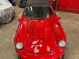 a red car that is parked in a garage