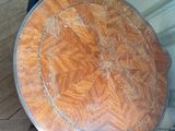 a small table with a wooden top on a wooden floor