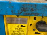 a blue and yellow parking meter with a yellow sign on it