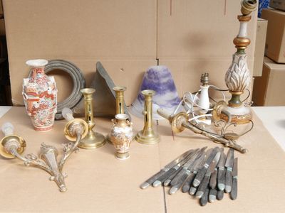 many different types of vases and candles on the table