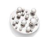 an image of a white plate with silver balls on it