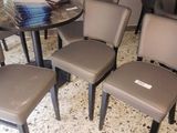 four chairs and a table in a room