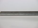 a close up of a metal tube on a white surface