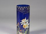 a blue vase with flowers on it on a white surface
