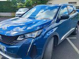 a blue suv parked in a parking lot next to a building