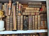 many old books on a shelf in a book store