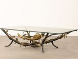 an image of a coffee table with a glass top and branches on it