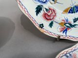 two plates with different designs on them on a table