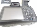 a camera that is sitting on a table next to a bag