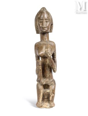 une image représentant une statue en bois d'une femme tenant un bébé dans ses bras