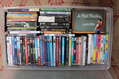 une boîte en plastique transparent remplie de DVD et de films