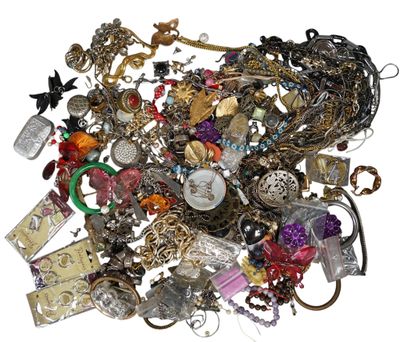 a pile of assorted jewelry on a white surface