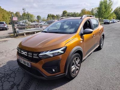 the orange car is parked on the side of the road