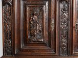 an old wooden cabinet with carvings and carvings on the doors