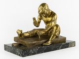 bronze statue of a man with a baby on a marble base