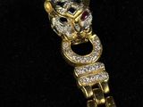 a close up of a gold bracelet with diamonds on it