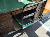 a green desk with a lamp on top of it