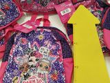 a lot of backpacks that are on the table