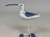 a small bird that is standing on a blue stand