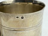 a silver cup that is sitting on a table