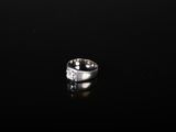 a close up of a diamond ring on a black surface