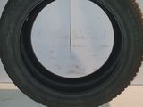 tire of a car on a white surface with a black rim