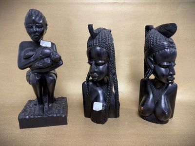 three african figurines sitting on top of a table next to each other