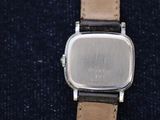 an image of a close up of a wrist watch on a blue cloth