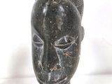 an image of a statue of a woman ' s head with a bird on her head